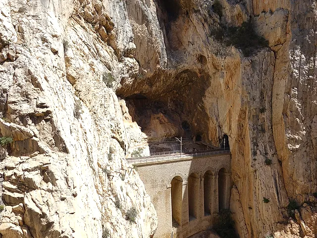 The old arched hydroelectric canal structure cut into the rock